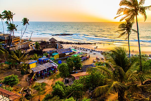 a beach with palm trees and buildings